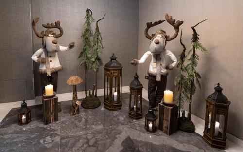two moose statues with candles in a room at Hotel Belmont & Spa in Sinaia
