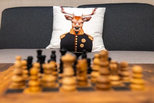 a chess board with a deer head dressed in a suit at Hotel Belmont & Spa in Sinaia