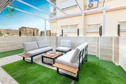 a patio with two chairs and a table at Luxury Home With Terrace in Málaga