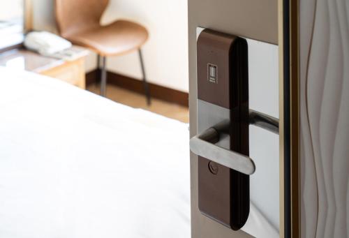 a close up of a refrigerator door with a chair at 二川行旅 - HiRiver Hotel in Taichung