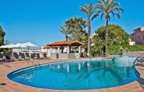 a large swimming pool with palm trees and a gazebo at BQ Augusta Hotel in Palma de Mallorca