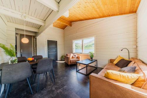 a living room with a couch and a table at Senja Fjordcamp in Torsken