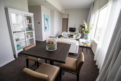 a living room with a table and chairs at Van der Valk Hotel Tiel in Tiel