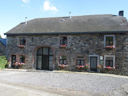 a brick building with flower boxes on the windows at Gite du Circuit in Stavelot