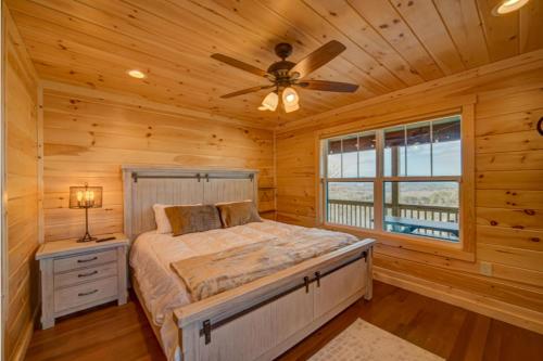 a bedroom with a bed and a ceiling fan at Mystic Mountain Lodge in Mineral Bluff