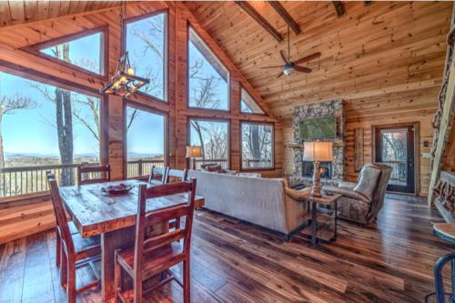 a dining room and living room in a log cabin at The Hideaway in Blue Ridge