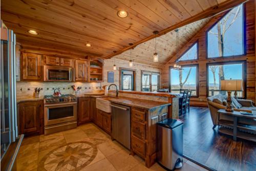 a kitchen with wooden cabinets and a living room at The Hideaway in Blue Ridge