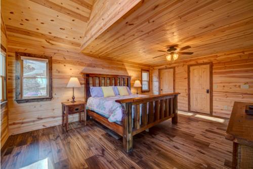 a bedroom with a bed in a log cabin at The Hideaway in Blue Ridge