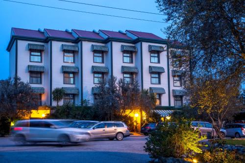 a car driving in front of a large building at Best Western Park Hotel Roma Nord in Fiano Romano