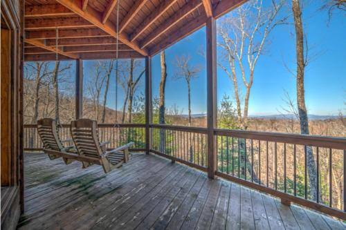 a screened in porch with two chairs on it at The Hideaway in Blue Ridge