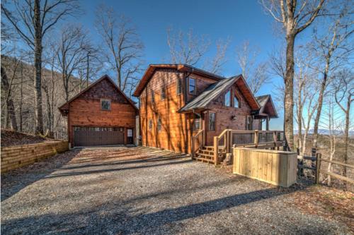 a log home with a garage and a fence at The Hideaway in Blue Ridge