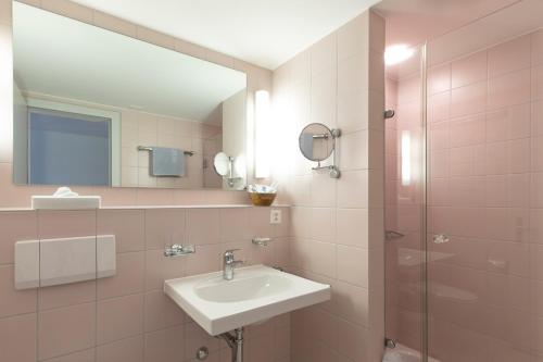 a bathroom with a sink and a mirror at LILIENBERG in Ermatingen