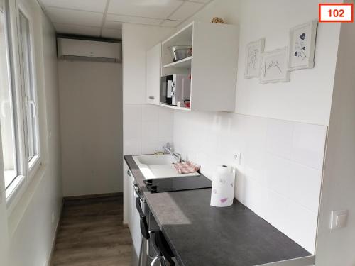a kitchen with a sink and a counter top at Immoappart in Albi