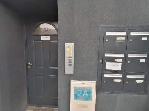 a wall with two doors and a sign in front of it at Immoappart in Albi