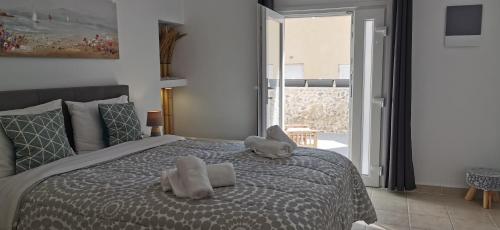 a bedroom with a bed with two stuffed animals on it at Alexandra's Home in Fira