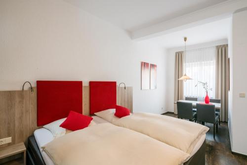 a hotel room with two beds with red pillows at Hotel Kemper in Havixbeck