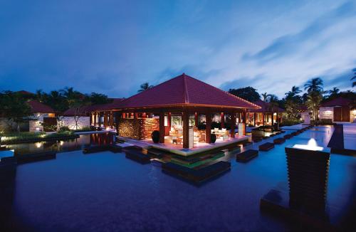 a resort with a swimming pool and a building at Grand Hyatt Bali in Nusa Dua