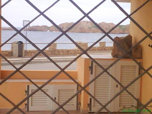a view from a window of a building with a view of the water at Miramare Isola Rossa in Isola Rossa