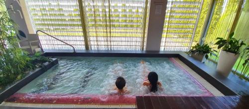 two girls swimming in a pool in a building at Hotel Kaj in Marija Bistrica