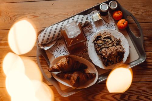a tray of food with pastries and bread on a table at Sojolidays - Appartements d'hôtes sur la Route des Vins d'Alsace in Rorschwihr