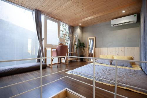 a bedroom with a bed and a table in a room at Soc House 1 in Vung Tau