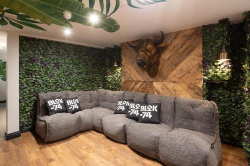 a living room with a couch and a cow head on the wall at Blok-74 in Brighton & Hove