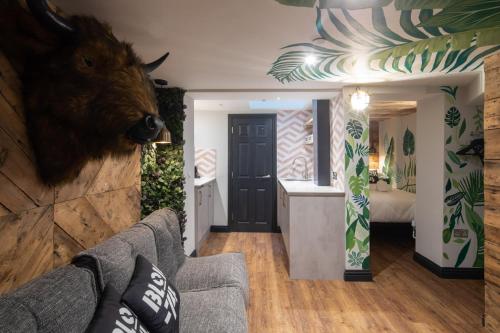 a living room with a couch and a bear head on the wall at Blok-74 in Brighton & Hove