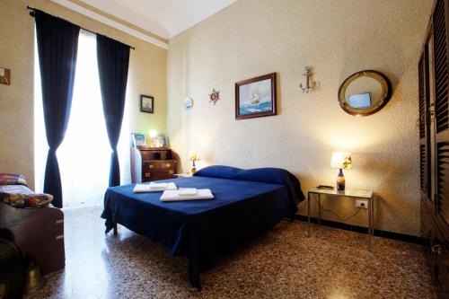 a bedroom with a blue bed with towels on it at NORMA in Levanto