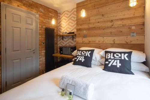 two beds in a room with wooden walls at Blok-74 in Brighton & Hove