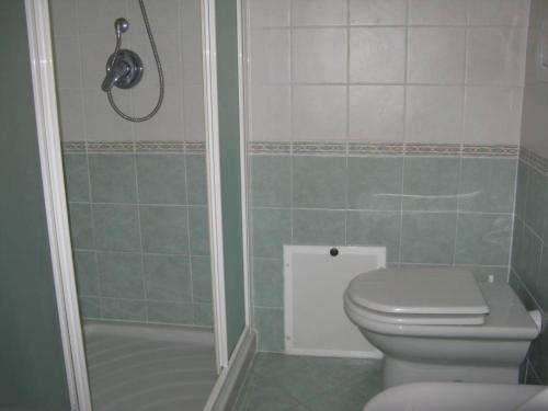 a bathroom with a toilet and a shower at Miramare Isola Rossa in Isola Rossa