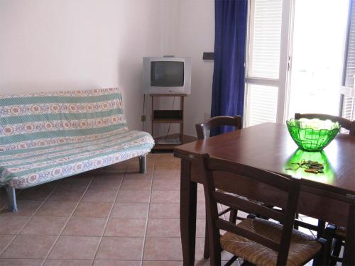 a living room with a table and a couch at Miramare Isola Rossa in Isola Rossa