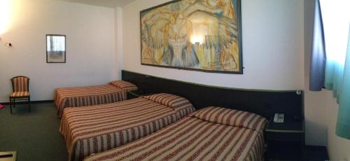 Una cama o camas en una habitación de Green Hotel