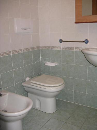 a bathroom with a toilet and a sink at Miramare Isola Rossa in Isola Rossa