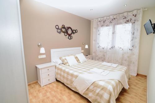 a small bedroom with a bed and a window at La Caseta - 5907 in Isla