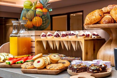 a buffet of bread and pastries on a table at Radisson Blu Hotel, Rouen Centre in Rouen