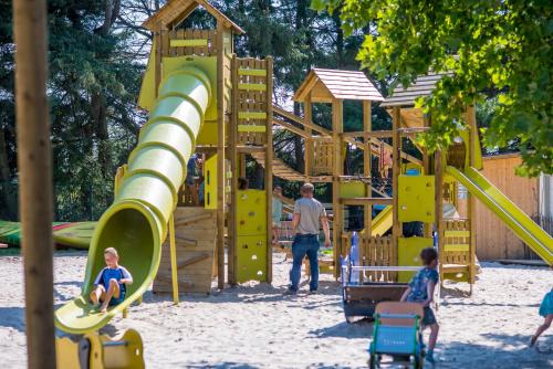 a group of children playing in a playground at ASILI DELUXE - Zebra in Lichtaart