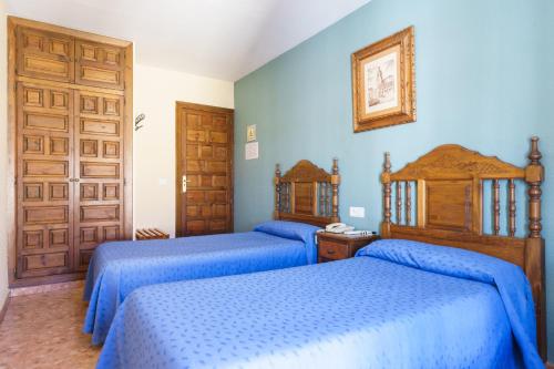 a bed room with two beds and a desk at Arunda I by Vivere Stays in Ronda