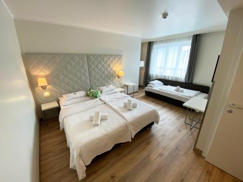 
a hotel room with two beds and a table at Safestay Vienna in Vienna
