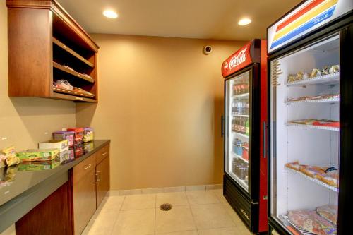 a kitchen with a coca cola refrigerator at Stanton Inn and Suites in Stanton