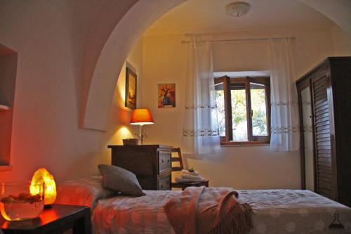 a bedroom with a bed and a window at Il Mandorlo in Ostuni