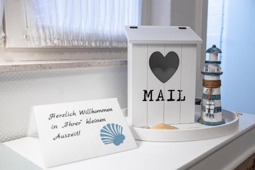 a box of mail sitting on a shelf next to a window at Hotel kleine Auszeit - Adults Only in Sankt Peter-Ording