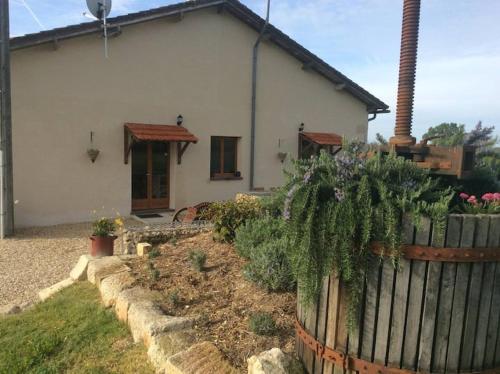 a house with a fence in front of a yard at Gite Charbonnaud in Laprade