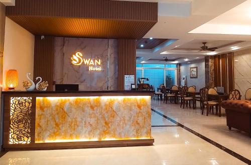 a lobby of a hotel with a swim up bar at Swan Hotel in Ho Chi Minh City