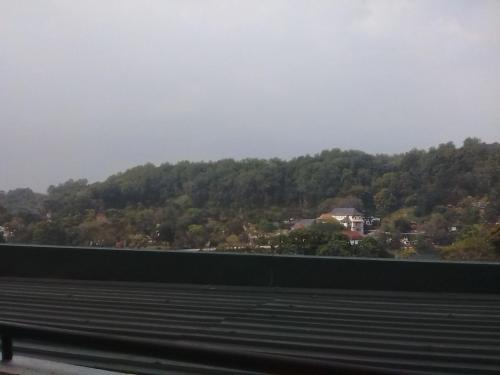 a view of a mountain from a train window at Heaven Seven Kandy in Kandy