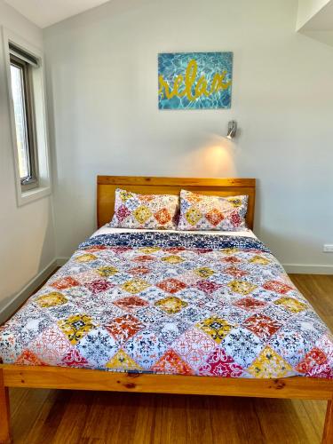 a bed with a colorful quilt on it in a bedroom at Home away from home newly built and spacious in Fairfield
