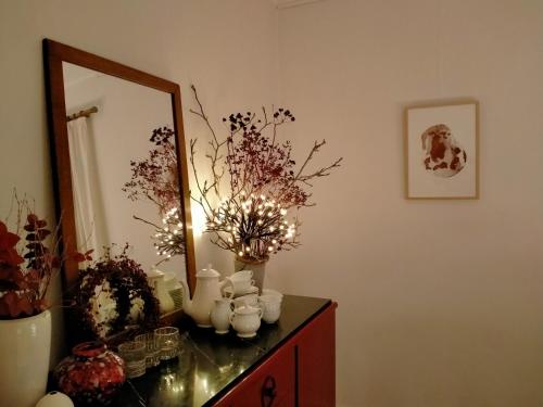 a room with a dresser with a mirror and vases at L'Aubergine in Sprimont