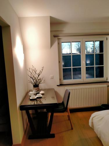 a small room with a table and a window at L'Aubergine in Sprimont