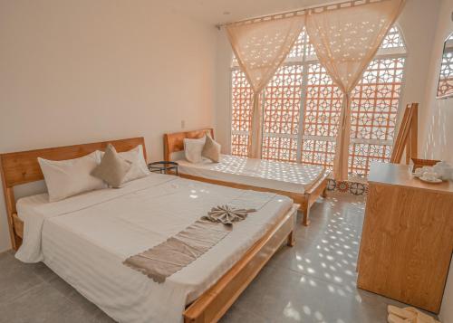 Postel nebo postele na pokoji v ubytování Mekong 69 Hostel