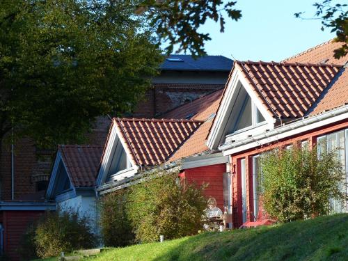 a red house with a red roof at Familienferienpark Dambeck in Kratzeburg
