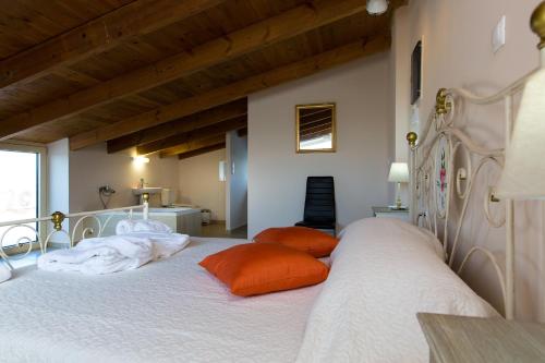 a bedroom with a bed with two pillows on it at Blue Mare Villa Rethimno in Magnisía